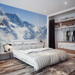 A bedroom with a mountain in the background
